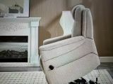 a recliner that is sitting in front of a fire place