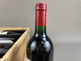 a bottle of red wine in a wooden box