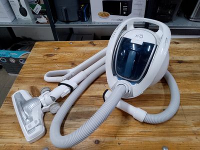 a vacuum that is sitting on a wooden table