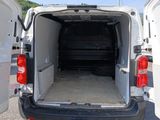 a white van with its doors open in a parking lot