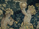 a tapestry with a picture of a man and a woman in a garden