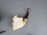 a pipe with a handle and a piece of wood on the table