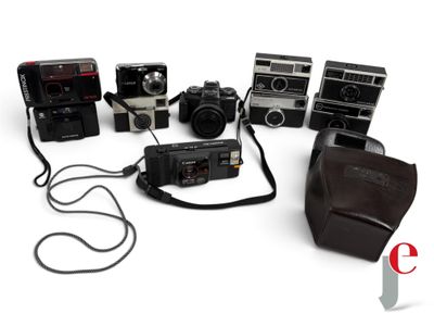 a lot of cameras that are sitting on a white surface