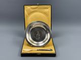 an antique silver plate with a spoon and knife in a case
