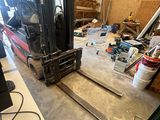 a forklift in a warehouse with a lot of tools