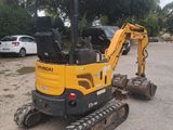 a small excavator that is parked in a parking lot