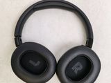 the black headphones are resting on a white surface