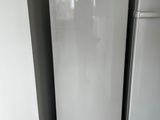 a white refrigerator and a white refrigerator freezer in a room