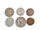 six different types of coins on a white surface