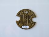 an image of a small metal object with a tag on it