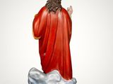 the statue of jesus is standing on a rock with a crown on his head