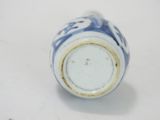 a small blue and white vase with a white base
