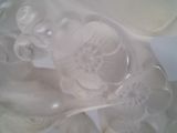 a glass figurine of a man and a woman on a table