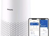Le purificateur d'air intelligent Philips se trouve à côté d'un iPhone et d'un smartphone