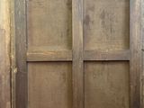 an old window with a wooden frame in the corner of a room