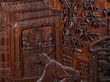 carved wood panel with a scene of a man and a woman in a garden