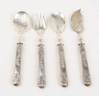 four spoons, forks and spoons are lined up on a white surface