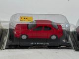 two red toy cars in a clear box on a table