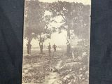 an old photo of a group of men standing in a field