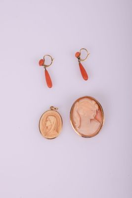 a pair of earrings and a coin with a picture of a woman on it