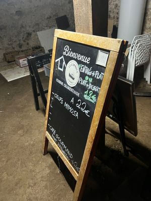 a chalk board with a sign on it in a room
