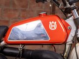 a close up of a red motorcycle with a mountain in the background