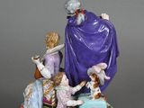 a figurine of a group of people sitting on a couch