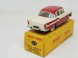 a red and white toy car sitting on top of a yellow box