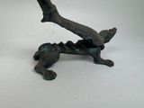 a statue of a dog that is sitting on a tree branch
