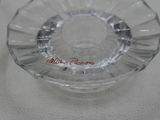 a glass ashtray on a table with a small glass ashtray in the middle