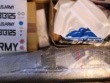 a cardboard box filled with many items and a sign