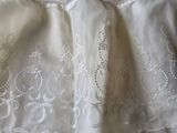 a white dress on a bed with a white comforter