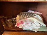 a wooden shelf with a bunch of towels on top of it
