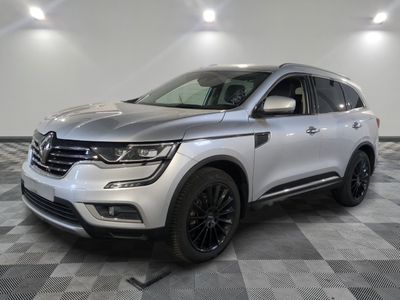 a silver suv parked on a checkered tile floor in a garage