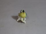 a small yellow bird sitting on top of a white table