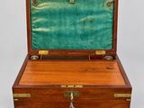 an old wooden box with a tassel in it sitting on a table