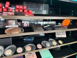 a display of cosmetics products in a store for sale