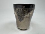 a black and silver vase sitting on a white table