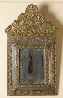 a mirror hanging on the wall with a person in it