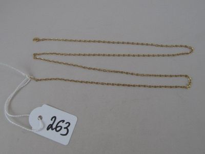a close up of a gold chain with a price tag on it