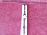 a watch that is laying on a red cloth