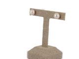 pair of pearl stud earrings on burlock fabric stand