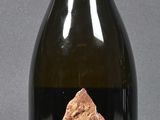 a bottle of wine with a piece of gold on it
