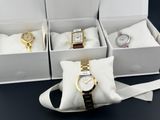 three boxes of watches are sitting on a black surface