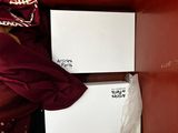 two boxes that are sitting on a red couch