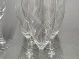 several empty wine glasses sitting on top of a table next to each other