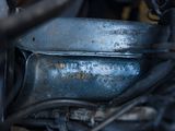 a close up of a motorcycle engine with a rusted cover