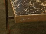 a table with a marble top and a metal frame on it