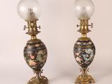 pair of antique lamps with floral designs and glass globes