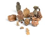many pieces of pottery that are sitting on a white surface
